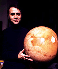 Dr. Carl Edward Sagan holding the planet Mars